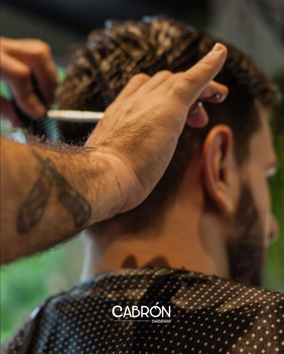 Detalhe do corte de cabelo com pente e tesoura
