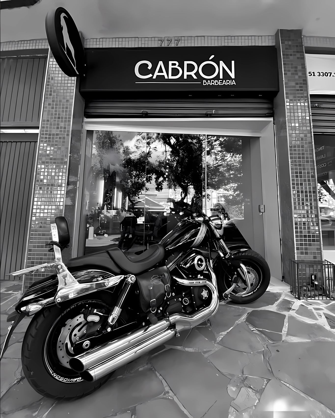 Fachada da Cabrón Barbearia à noite